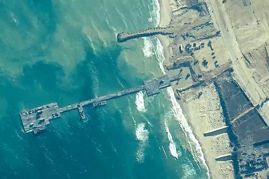 Members of the U.S. Army, U.S. Navy and the Israeli military put in place the Trident Pier, a temporary pier to deliver humanitarian aid, on the Gaza coast, amid the ongoing conflict between Israel and the Palestinian Islamist group Hamas on May 16, 2024 — US Central Command/Handout via REUTERS
