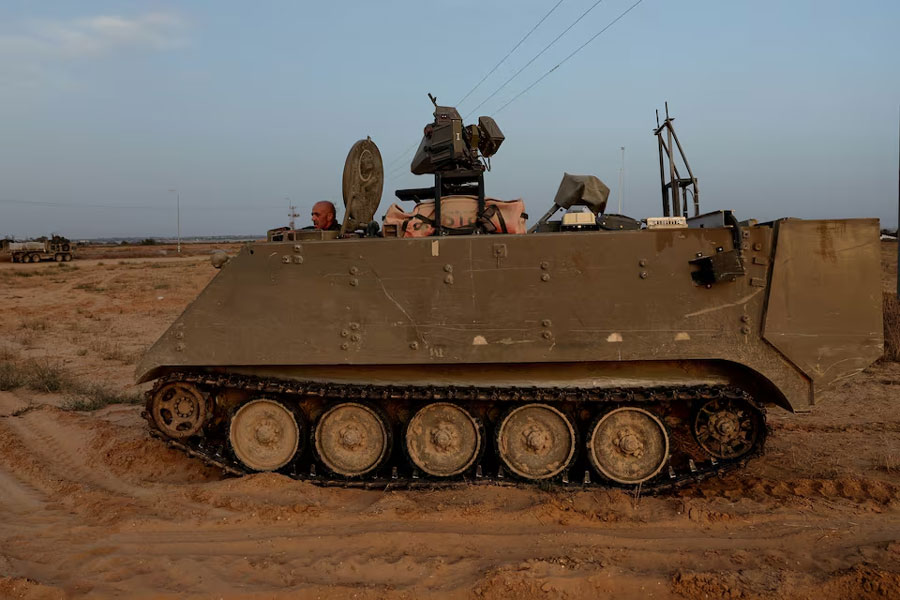 An Israeli solider drives an armored personnel carrier, as military operations continue in the southern Gaza city of Rafah, at an area outside Kerem Shalom, Israel, May 17, 2024.