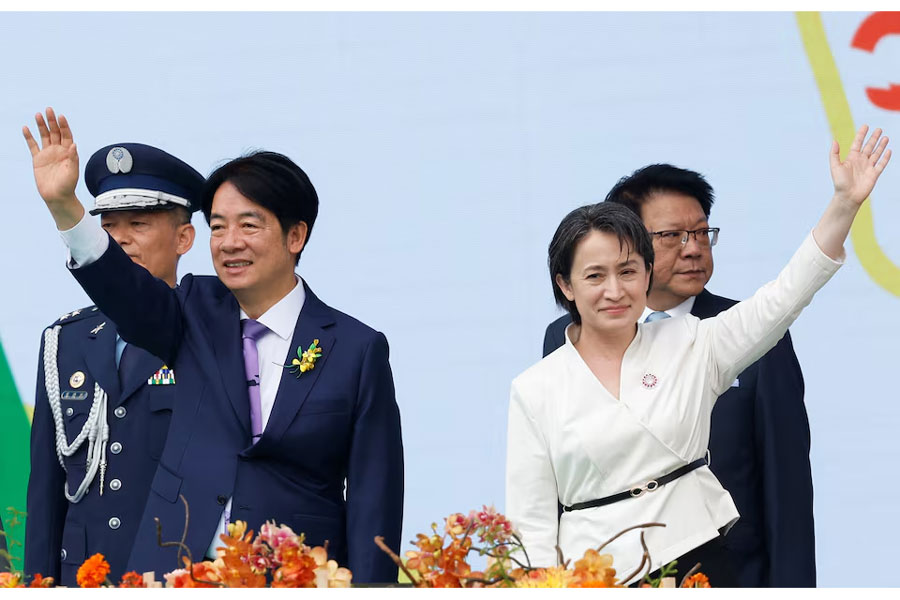 Taiwan's new President Lai Ching-te and new Vice President Hsiao Bi-khim wave during the inauguration ceremony outside the Presidential office building in Taipei, Taiwan May 20, 2024.