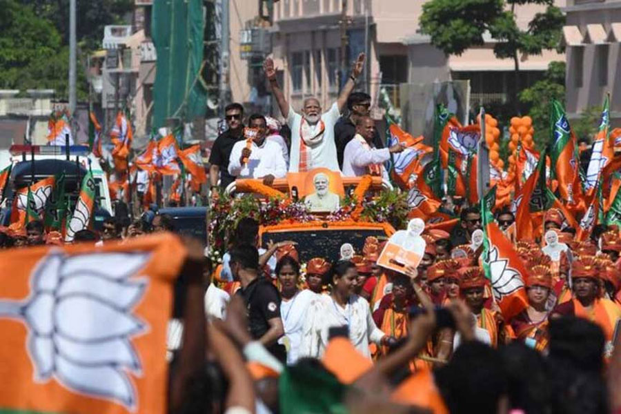 India’s Prime Minister Narendra Modi waves to his supporters during a roadshow as part of his election campaign during the ongoing general election, in Puri district of the eastern state of Odisha, India, May 20, 2024.