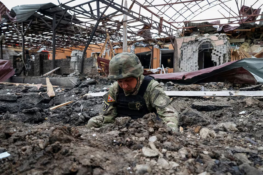 A Police bomb squad member works at the site of a Russian air strike, amid Russia's attack on Ukraine, in Kharkiv, Ukraine May 22, 2024.
