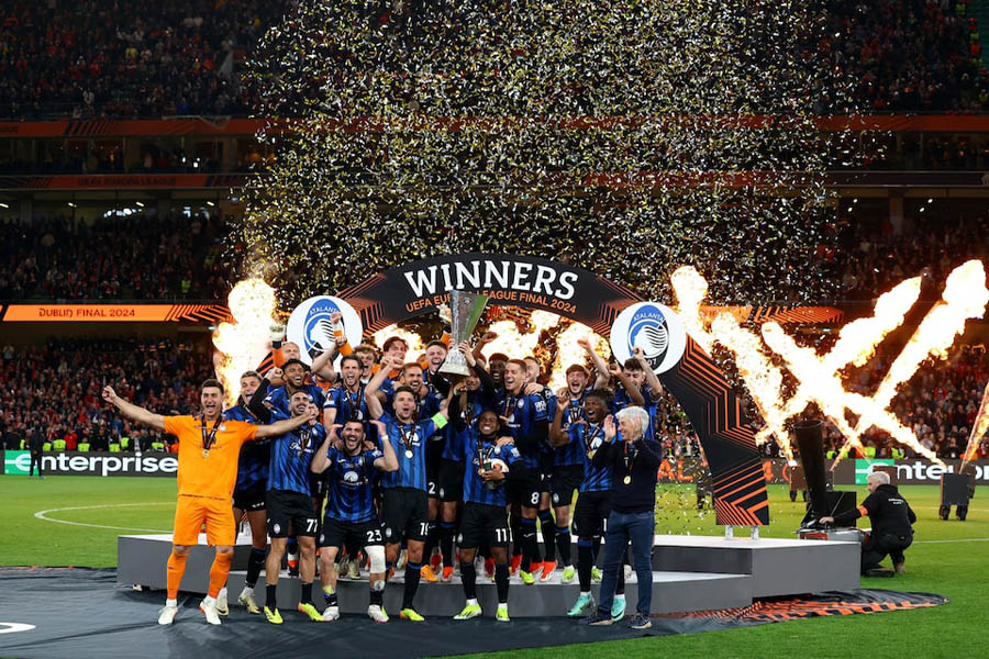 Atalanta's Berat Djimsiti lifts the trophy with teammates to celebrate winning the Europa League Final