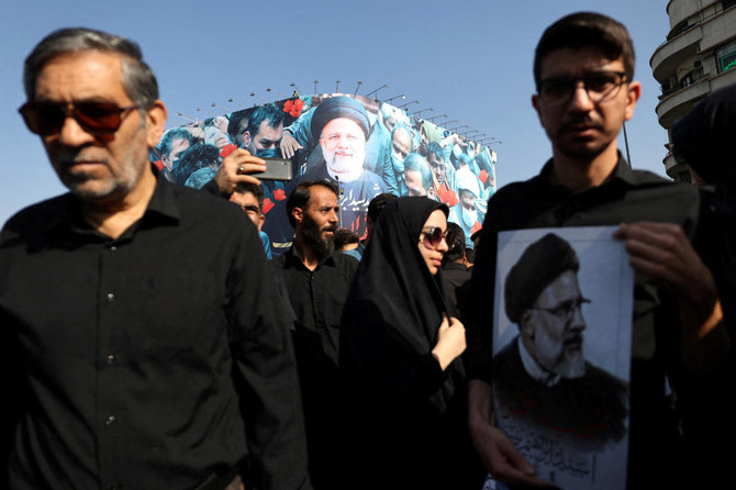 Mourners attend a funeral for victims of the helicopter crash that killed Iran’s President Ebrahim Raisi, Foreign Minister Hossein Amirabdollahian and others, in Tehran. (REUTERS)