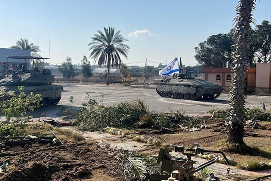 Israeli military vehicles operate in the Gazan side of the Rafah Crossing, amid the ongoing conflict between Israel and Palestinian Islamist group Hamas, in the southern Gaza Strip, in this handout image released on May 7, 2024.