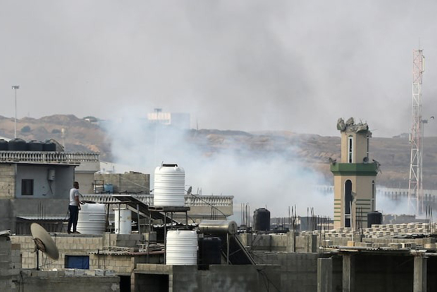 A man looks on as smoke rises following Israeli strikes during an Israeli military operation in Rafah, in the southern Gaza Strip on May 28, 2024 — Reuters/Files