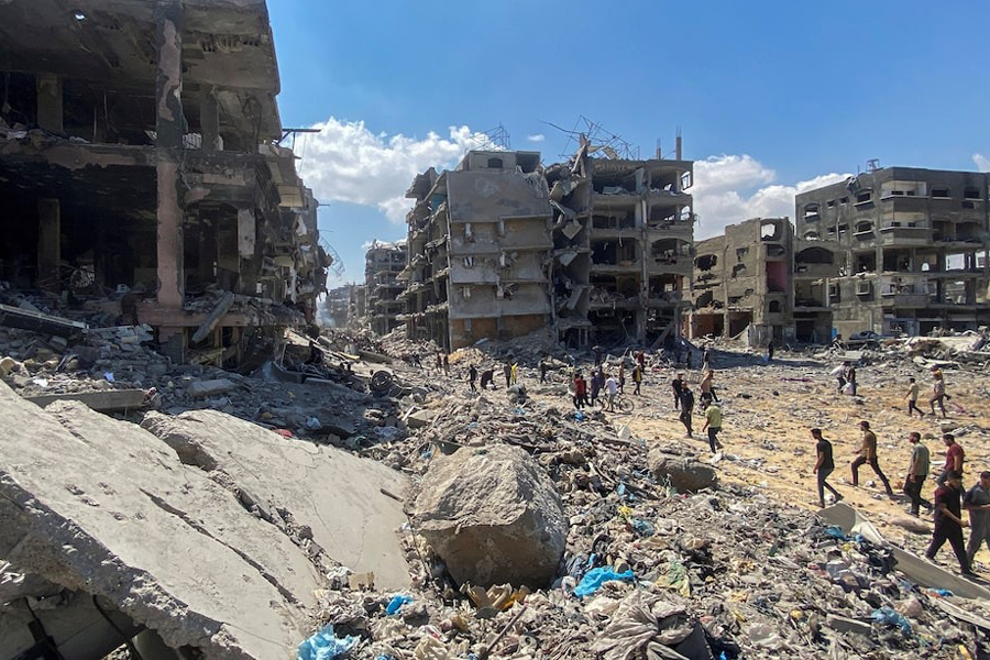 Palestinians make their way as they inspect the damages after Israeli forces withdrew from a part of Jabalia refugee camp, following a raid, in the northern Gaza Strip, May 30, 2024.