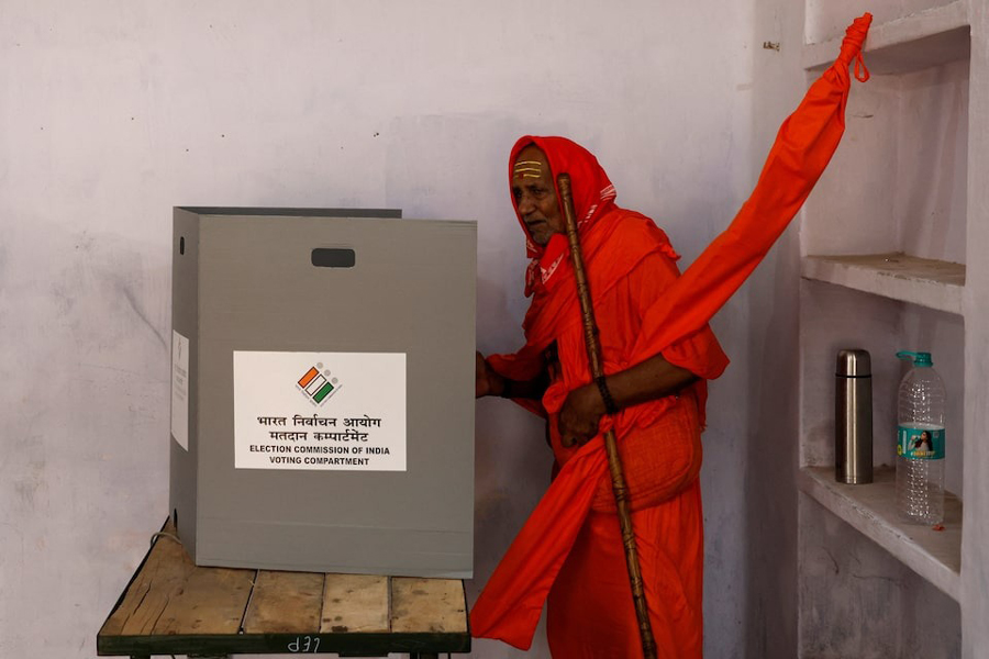 A Sadhu or a Hindu holy man casts his vote inside a polling station during the seventh and last phase of India's general election in Varanasi, India, June 1, 2024.