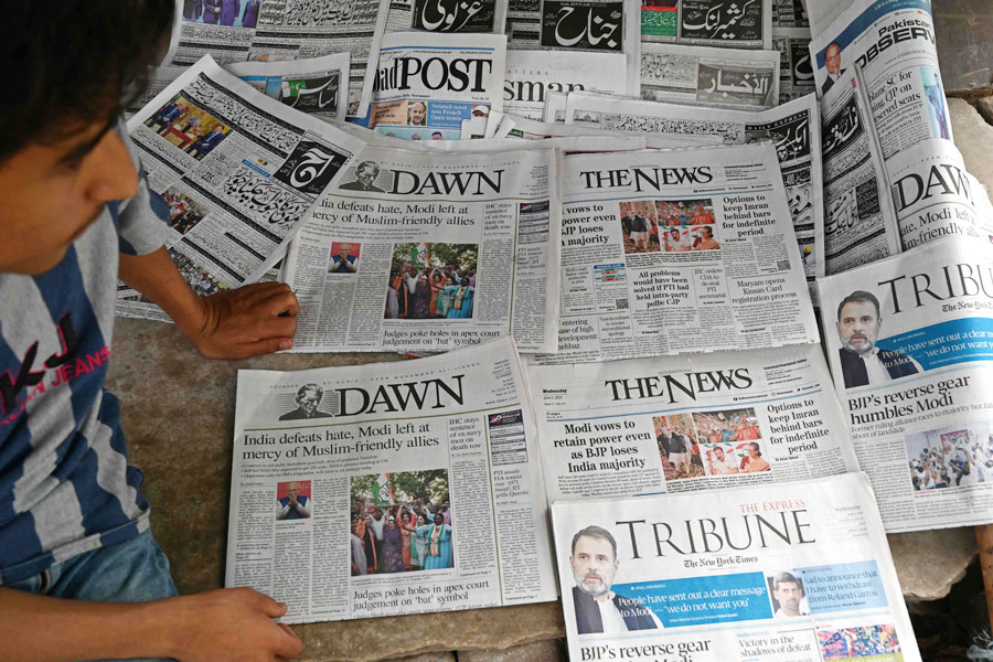 Pakistan’s newspapers with front page of India’s general election results are pictured along a street in Islamabad on June 5, 2024. The alliance led by Indian Prime Minister Narendra Modi’s Hindu-nationalist Bharatiya Janata Party (BJP) secured a parliamentary majority at the country’s general election, official results showed late Tuesday