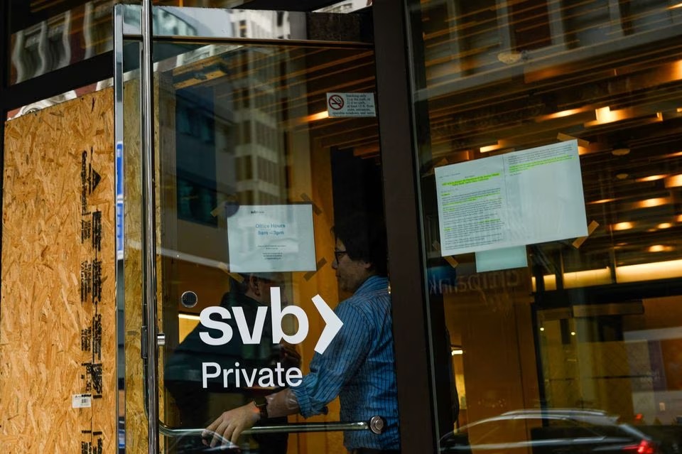 A Silicon Valley Bank employee holds the door for a customer at the bank's branch office in downtown San Francisco, California, US on March 13, 2023 — Reuters photo
