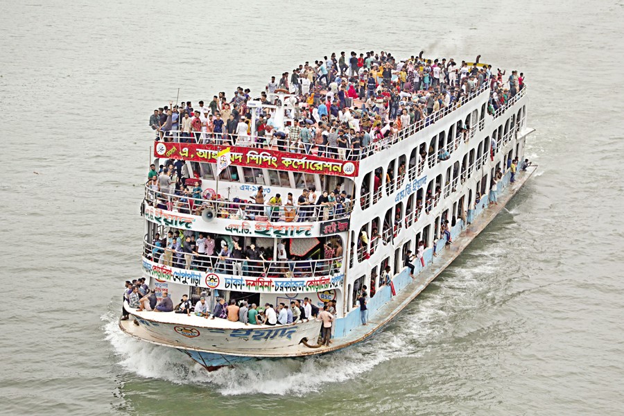 Homebound people depart Dhaka for their ancestral villages on a crowded launch to celebrate Eid-ul-Azha with loved ones. The photo was taken from Postogola Bridge on the Buriganga River on Saturday. — FE Photo