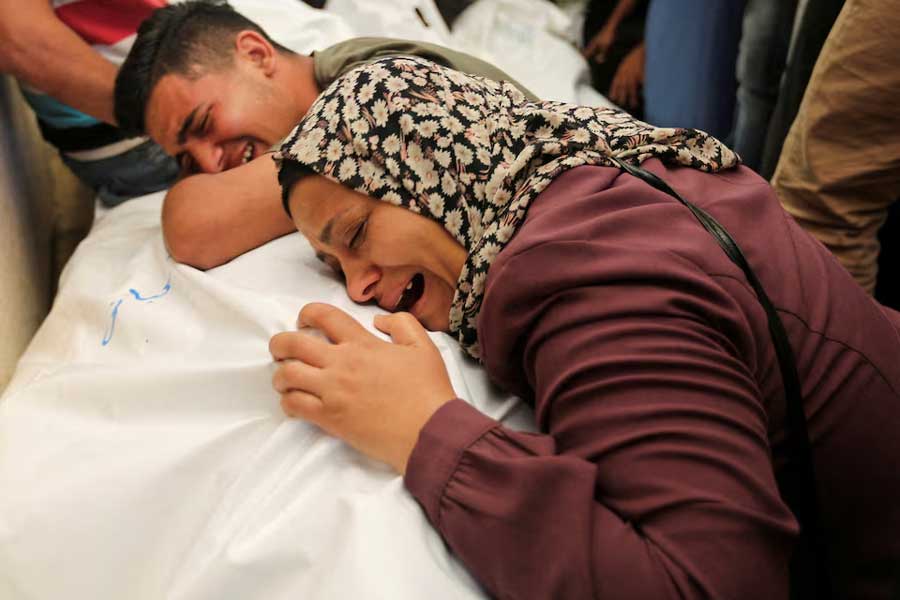 Mourners react next to the bodies of Palestinians, killed in Israeli strikes due to a military operation in Rafah, amid the Israel-Hamas conflict, during their funeral in Khan Younis, in the southern Gaza Strip, June 18, 2024.