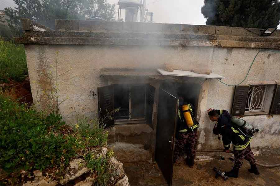 Firefighters working at a Palestinian house, which Palestinians say was attacked by Israeli settlers, near Ramallah in the Israeli-occupied West Bank on Sunday -Reuters photo