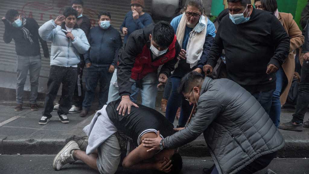 People help a man stunned by a flash grenade thrown by military police during a coup attempt against the government of Bolivian President Luis Arce by military units led by General Juan Jose Zuniga, in La Paz, Bolivia June 26, 2024. REUTERS