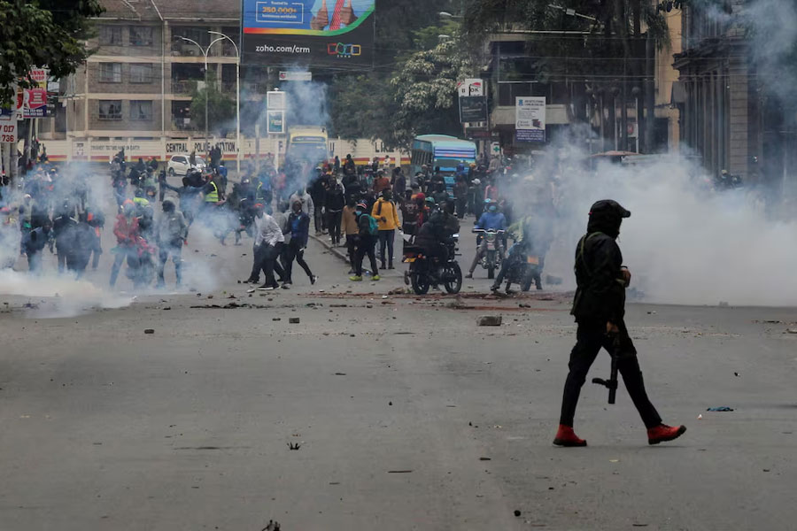 A police officer walks after using tear gas to disperse protesters during a demonstration over police killings of people protesting against Kenya's proposed finance bill 2024/2025, in Nairobi, Kenya, June 27, 2024.
