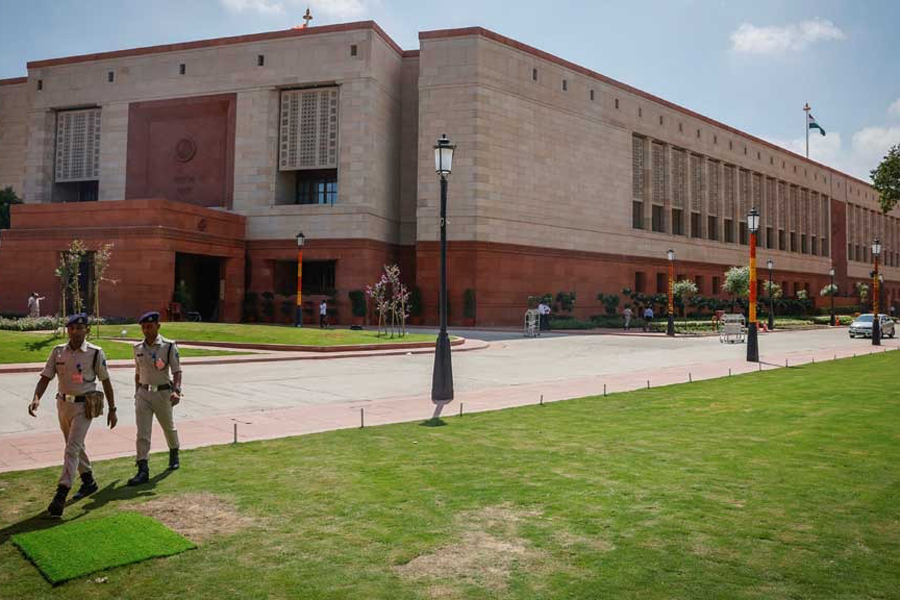 Police officers walk in front of India’s new parliament building a day before its inauguration in New Delhi, India, September 18, 2023.