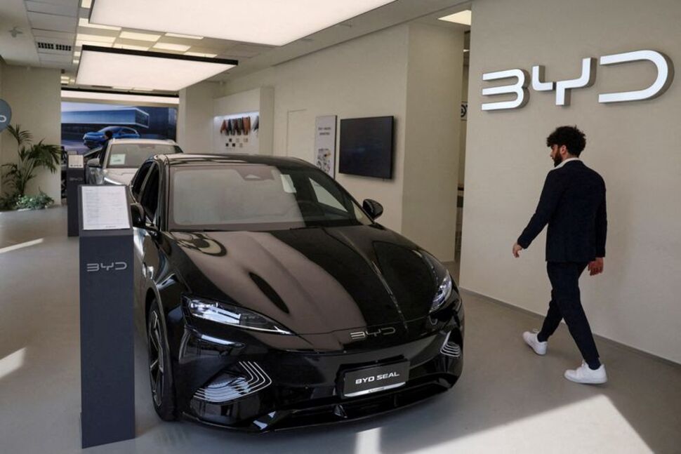 A person walks next to BYD Seal car in a BYD Auto company and Autotorino store in Milan, Italy, March 20, 2024. REUTERS/Claudia Greco/File Photo