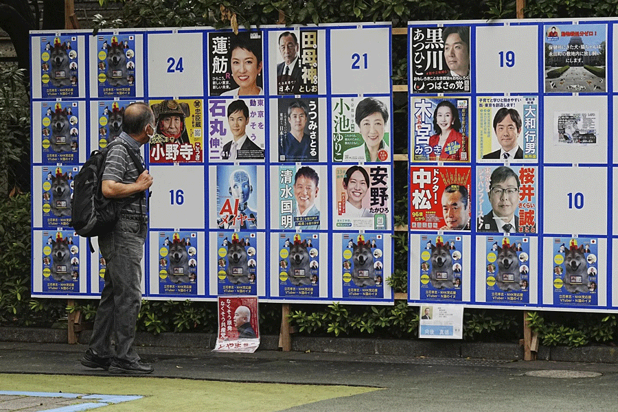 A person looks at an election poster board for Tokyo gubernatorial election Monday, July 1, 2024, in Tokyo. Tokyo elects a new governor on Sunday, July 7, but residents say personal publicity stunts have overtaken serious campaigning to a degree never seen before. There are nearly nude women in suggestive poses, pets, an Al character and a man practicing his golf swing.