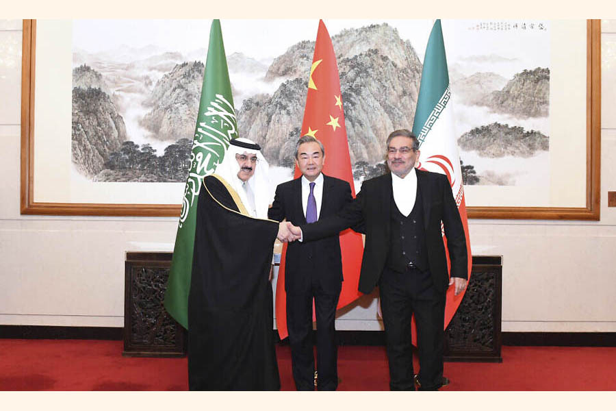 Ali Shamkhani, the secretary of Iran's Supreme National Security Council, at right, shakes hands with Saudi national security adviser Musaad bin Mohammed al-Aiban, at left, as Wang Yi, China's most senior diplomat, looks on, at centre, for a photo during a closed meeting held in Beijing on March 11, 2023—Xinhua Photo