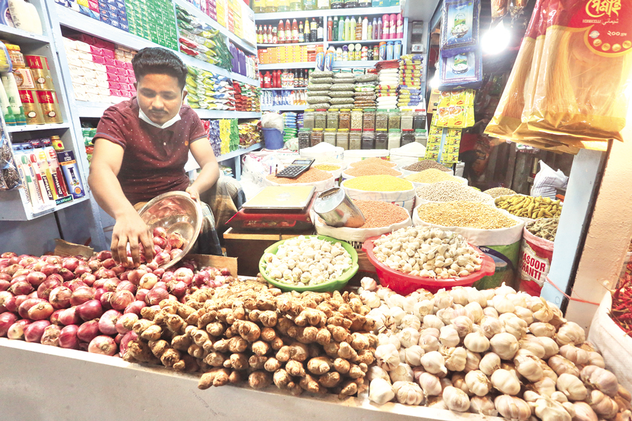 A vendor is seen arranging onions at his shop in Dhaka. Despite some relief at the global level, there is little respite from rising commodity prices in the domestic market —FE File Photo