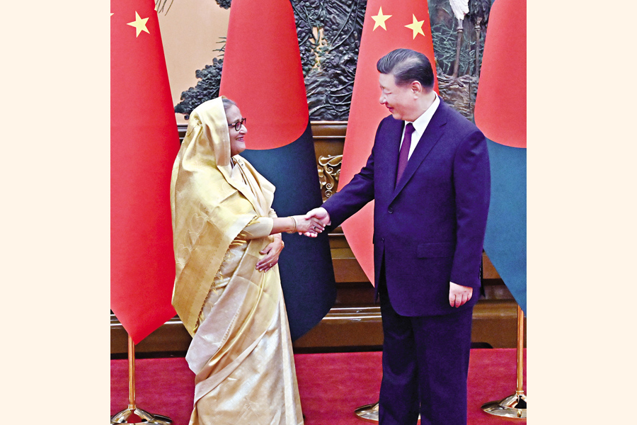 Chinese President Xi Jinping greets Prime Minister Sheikh Hasina as she arrives at the Great Hall of the People in Beijing for their bilateral meeting on Wednesday. — Photo PID