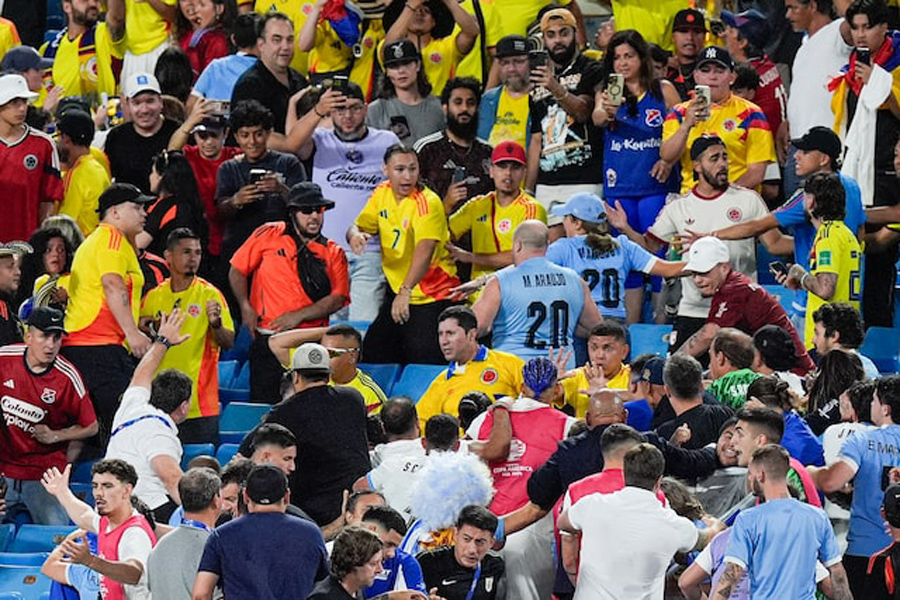 Fans get into an altercation with players and staff from Uruguay after the Copa Armerica Semifinal match between Uruguay and Colombia