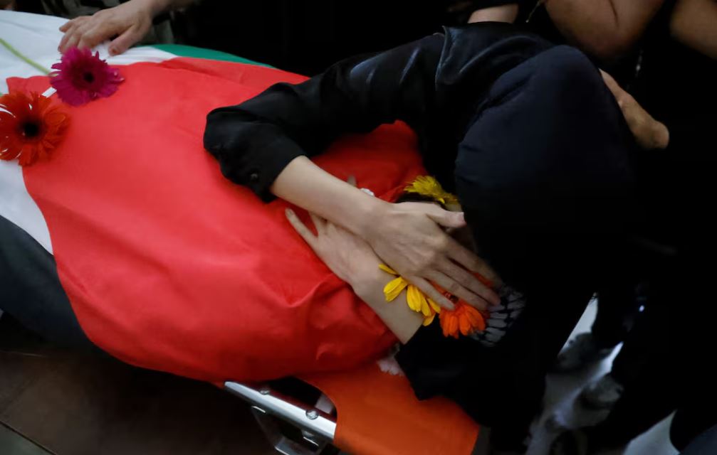 Mourners react at the body of a Palestinian who was killed by Israeli forces, during his funeral in Ramallah, in the Israeli-occupied West Bank July 16, 2024. REUTERS/Mohammed Torokman