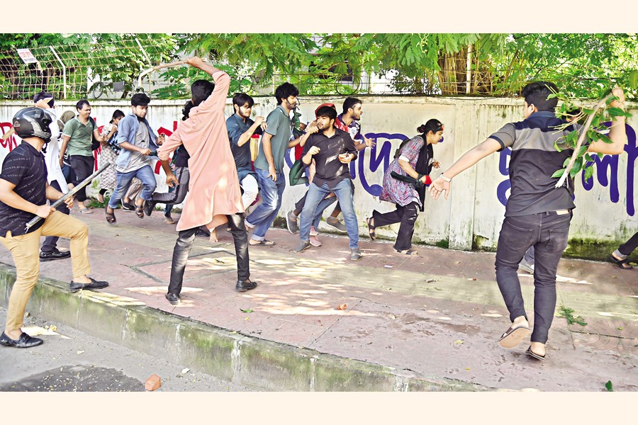 Ruling Awami League's student wing Chhatra League leaders and activists, wearing helmets and wielding sticks, attack protesters demanding reform of civil service job quotas on Dhaka University campus on Monday. —FE file photo