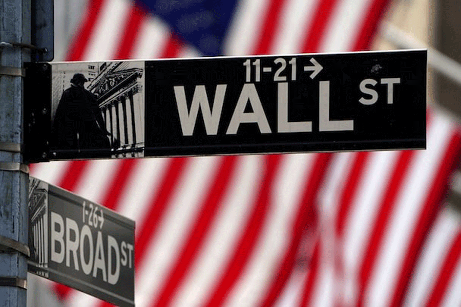 A Wall Street sign is pictured outside the New York Stock Exchange, New York City, US, April 16, 2021.