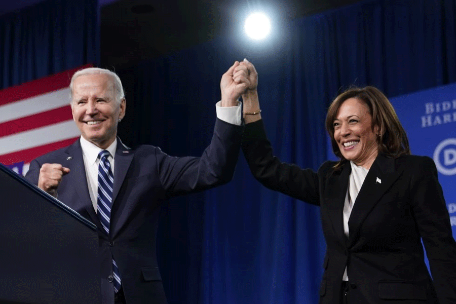 President Joe Biden and Vice President Kamala Harris stand on stage at the Democratic National Committee winter meeting, Feb 3, 2023, in Philadelphia.