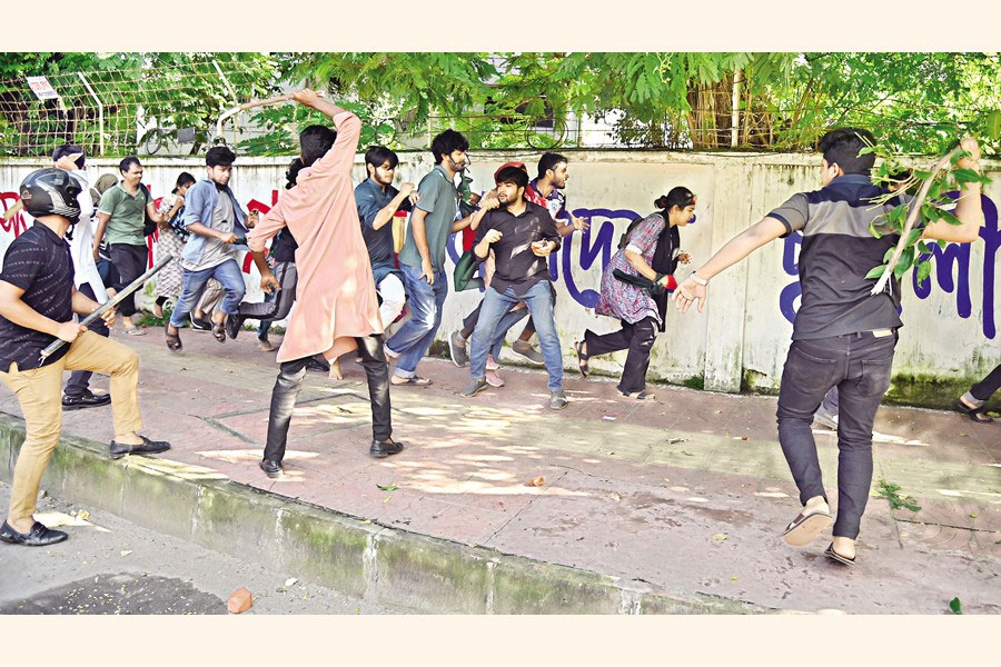 Ruling Awami League's student wing Chhatra League leaders and activists, wearing helmets and wielding sticks, attack protesters demanding reform of civil service job quotas on Dhaka University campus July 15.