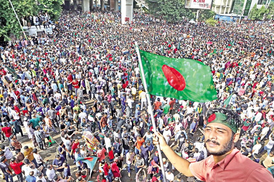 Thousands of jubilant people cheer and wave flags at Shahbagh intersection in Dhaka on Monday, after Prime Minister Sheikh Hasina resigned and left the country. Her departure defused tensions that had been rising during weeks of deadly demonstrations against the government. —FE file photo by Shafiqul Alam