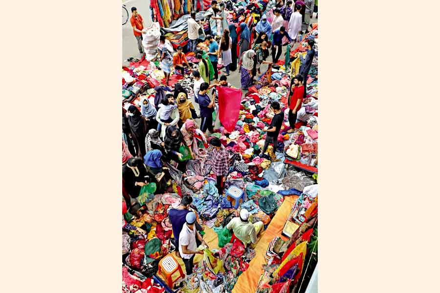 People shopping at the holiday market at Motijheel in Dhaka on Friday ahead of the Eid-ul-Fitr —FE photo by Shafiqul Alam