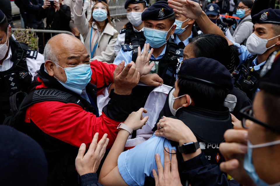 A supporter scuffles with police the West Kowloon Magistrates' Courts building during the hearing of the 47 pro-democracy activists charged with conspiracy to commit subversion under the national security law, in Hong Kong, China February 6, 2023. REUTERS/Tyrone Siu
