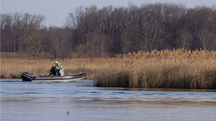 Police search the marshland where bodies were found in Akwesasne, Quebec, Canada, Mar 31, 2023. REUTERS