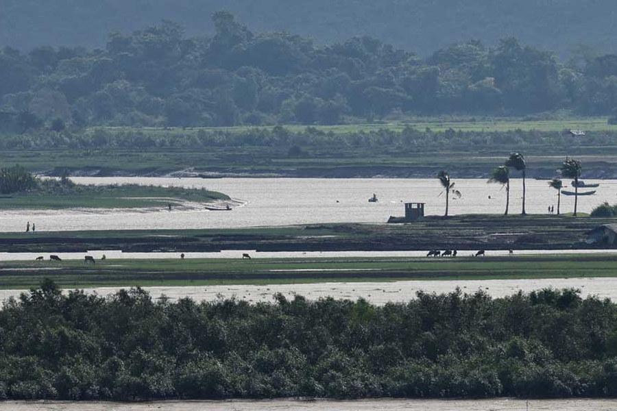 People of Maungdaw township of Myanmar are seen from the Teknaf area of Bangladesh, at the Myanmar-Bangladesh border, during the ongoing conflict in the Rakhine state of Myanmar, in Cox’s Bazar, Bangladesh, June 27, 2024.