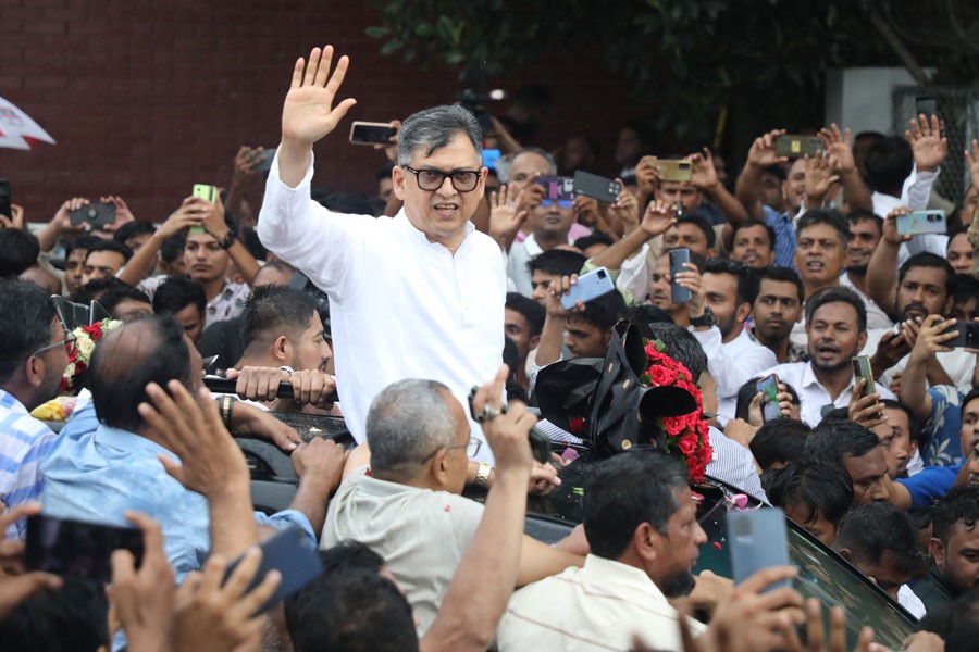 BNP Standing Committee Member Salahuddin Ahmed waving to supporters at the Hazrat Shahjalal International Airport after returning to the capital from India after nine years