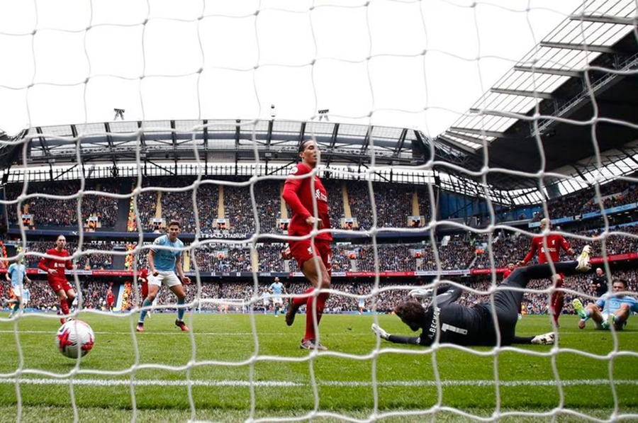 Manchester City's Jack Grealish scores their fourth goal past Liverpool's Alisson during their Premier League face off at Etihad Stadium in Manchester, Britain on April 1, 2023 — Reuters photo