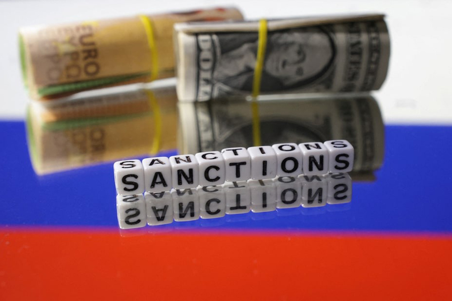 Euro and Dollar banknotes and words “Sanctions” are placed on Russian flag in this illustration taken, May 16, 2024.