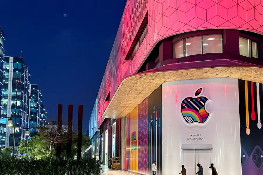 People walk past the barricade of India's first Apple retail store, that will be launched soon, at Jio World Drive Mall, Mumbai, India, April 5, 2023.