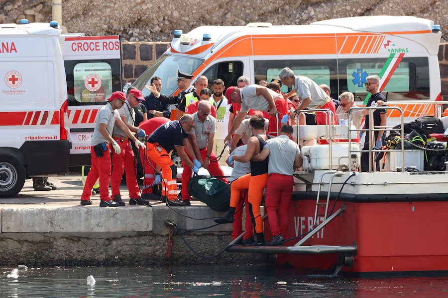 Emergency services carry a body bag after a sailboat sank in the early hours of Monday, off the coast of Porticello, near the Sicilian city of Palermo, Italy, August 19, 2024.