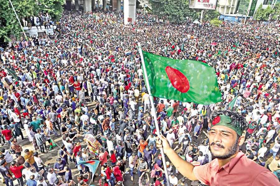 Thousands of jubilant people cheer and wave flags at Shahbagh intersection in Dhaka on Monday, after Prime Minister Sheikh Hasina resigned and left the country. Her departure defused tensions that had been rising during weeks of deadly demonstrations against the government