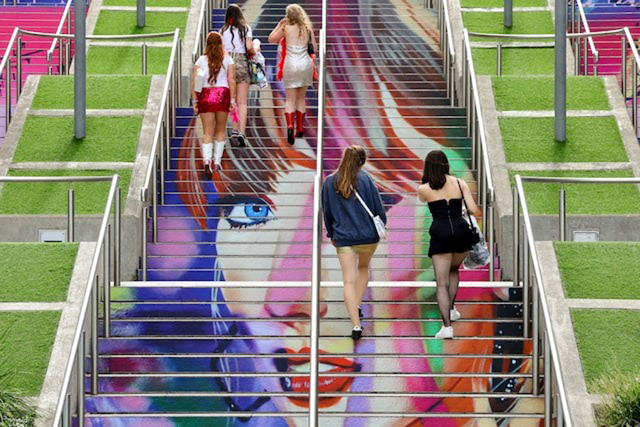 People walk on the ‘Swiftie Steps’ ahead of a Taylor Swift concert, following the cancellation of three Taylor Swift concerts in Vienna because of a planned attack, at Wembley Stadium in London, Britain, August 15, 2024.