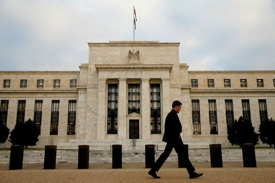A man walks past the Federal Reserve in Washington, December 16, 2015.