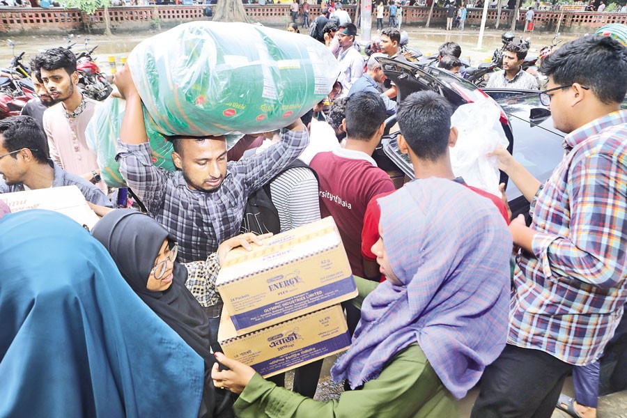 With food supplies, people crowd the TSC area of Dhaka University on Friday as students collect relief materials for flood-affected people in eastern and southeastern Bangladesh. — FE Photo by Shafiqul Alam