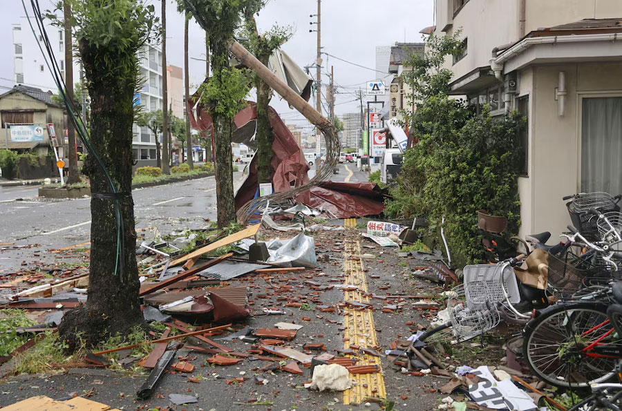 Debris and objects blown by strong winds caused by Typhoon Shanshan are seen on a sidewalk of a road in Miyazaki, southwestern Japan, August 29, 2024, in this photo taken by Kyodo.