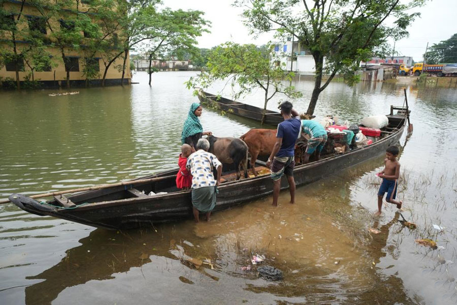 Villagers transfer personal belongings in Sylhet region, Bangladesh on June 22, 2024