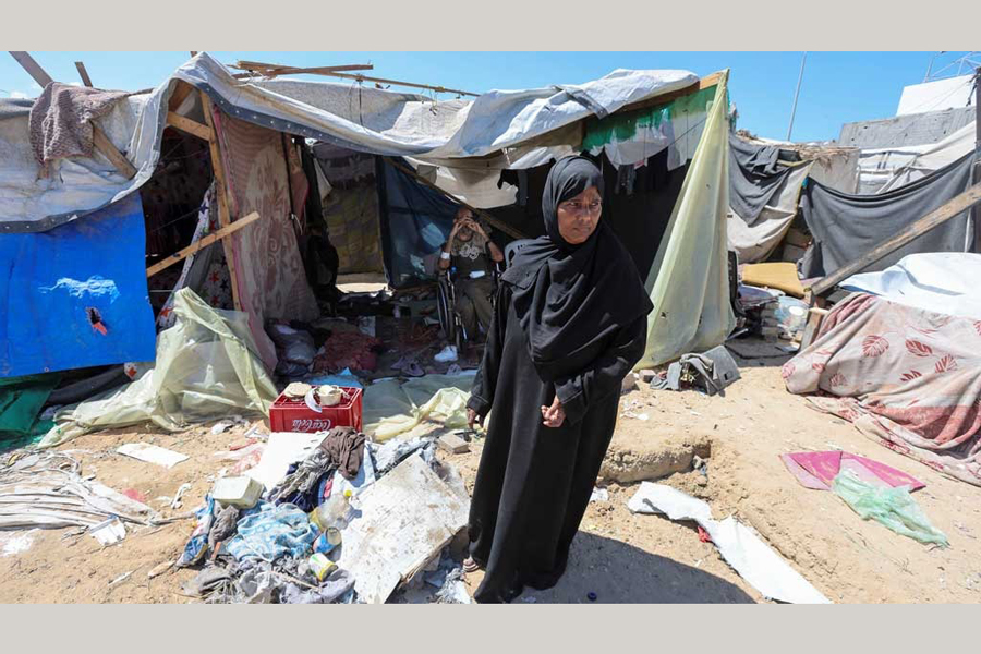 Displaced woman Iqbal Al-Zeidi stands in front of her tent which was torn by an Israeli strike, on the courtyard of Al-Aqsa Martyrs hospital, amid the Israel-Hamas conflict, in Deir Al-Balah in the central Gaza Strip, Sept 5, 2024.