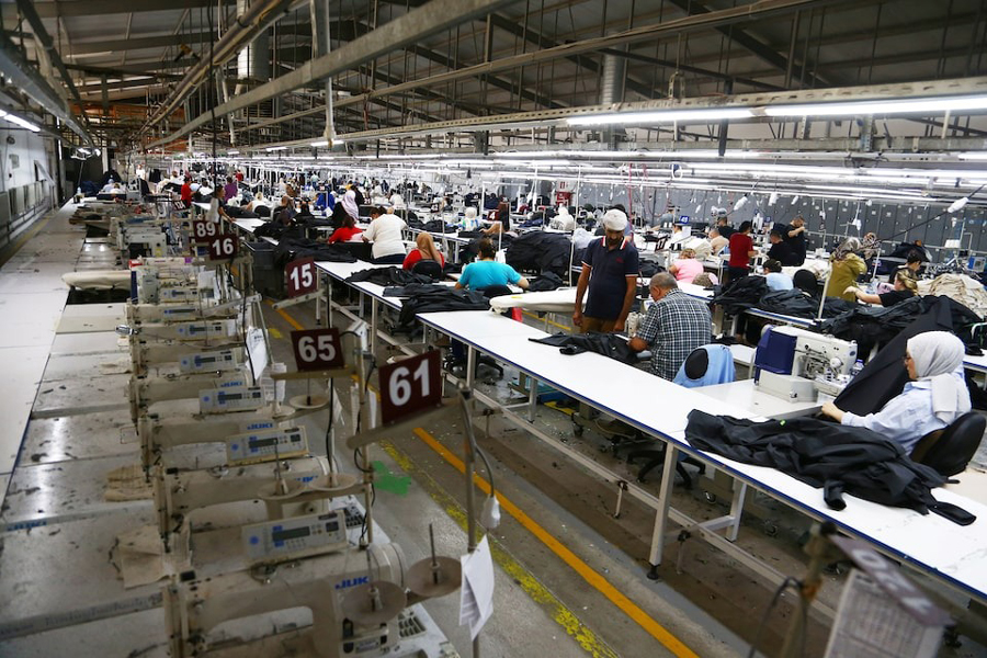 Employees work next to an empty production line at a garment factory in the organized industrial zone in Corum, Turkey, August 23, 2024.