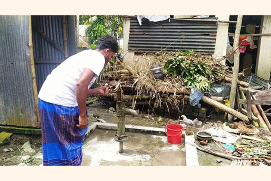 A man trying in vain to get pure water from a tube-well, which was left out of order by flooding, at Koya village in Shahrasti upazila of Chandpur district