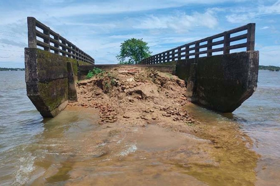 An approach road of a bridge on the Madhyanagar road had been washed away by the repeated floods in years